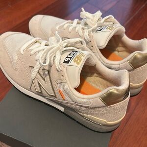 New Balance Beige and Metallic Gold Sneakers